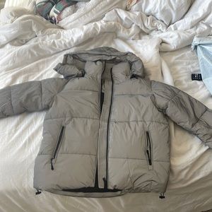 The mother puffer jacket. It’s Grey/ reflective and brand new with tags.